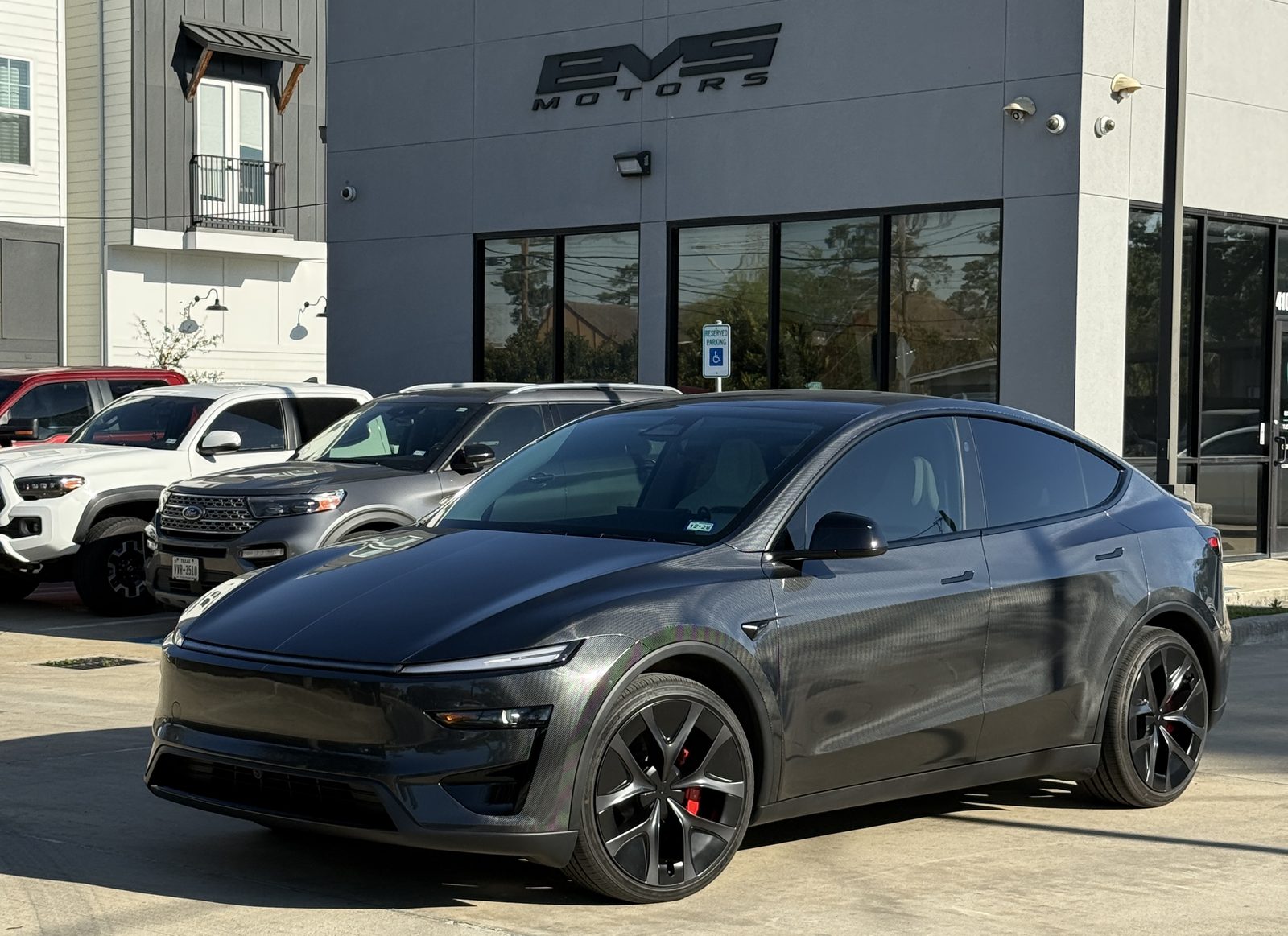 New Tesla Model Y parked in front of the EVS Motors shop in Houston